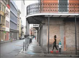  ?? Scott Olson Getty Images ?? NEW ORLEANS’ French Quarter was nearly empty Saturday as Barry bore down on the Gulf Coast. Parts of Louisiana had yet to see serious rain by day’s end.
