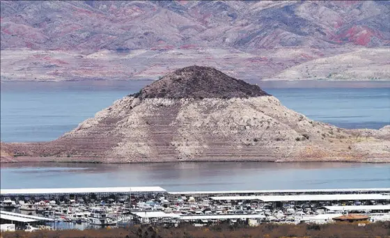  ?? JERRY HENKEL/LAS VEGAS REVIEW-JOURNAL ?? The “bathtub ring” can be seen at the Boulder Basin Las Vegas Boat Harbor Thursday at Lake Mead. The ring shows the effects of drought.