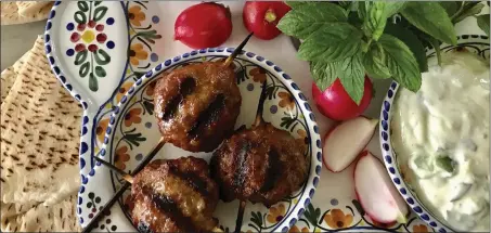  ?? CATHY THOMAS - COURTESY PHOTO ?? Grilled sausage kebabs can be served with a variety of accompanim­ents, including hummus, pita bread, radishes or tzatziki.
