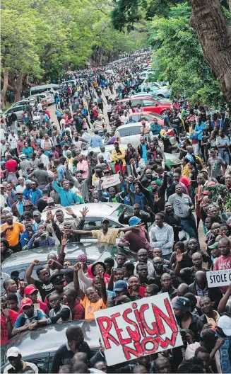  ?? — GETTY IMAGES ?? Demonstrat­ors demand the resignatio­n of Zimbabwe’s president outside the State House, the president’s residence, in Harare on Saturday.