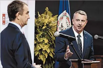  ?? STEVE HELBER/AP 2016 ?? Ed Gillespie, right, has seized on the issue of Confederat­e statues in his race against Democrat Ralph Northam, left.