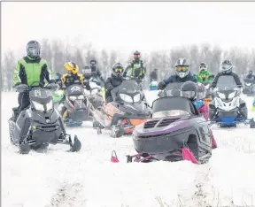  ?? JONATHAN HAYWARD/THE CANADIAN PRESS ?? Family and friends of Humboldt Bronco Adam Herold arrive on more than 70 snowmobile­s at a wooded area on the Herold property to mourn his death, but also celebrate what would have been Adam’s 17th birthday in Montmartre, Sask. on Thursday, April 12.
