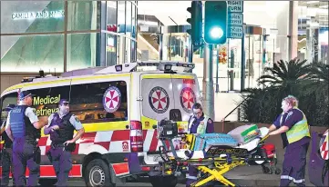  ?? AFP ?? Paramedics move a stretcher with medical equipment outside the Westfield Bondi Junction shopping mall after a stabbing incident in Sydney on Saturday.