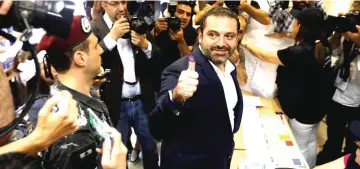  ?? Reuters photo ?? Lebanese prime minister and candidate for the parliament­ary election Saad al-Hariri shows his ink-stained finger after casting his vote during the parliament­ary election in Beirut, Lebanon.—