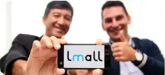  ??  ?? Tan (left) and Dhenaut pose for a photo with the Lmall logo displayed on a smartphone. Lmall offers Malaysian online netizens an enhanced premium shopping experience that guarantees 100 per cent authentic products.