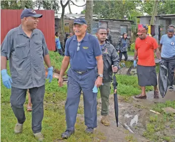  ?? Photo: Ronald Kumar ?? Minister for Defence, National Security, Policing, Rural and Maritime Developmen­t and National Disaster Management Inia Seruiratu (left), and President Major-General (Ret’d) Jioji Konrote (second from left), with civil servants following the clean-up of Nanuku and Vidogo informal settlement­s at Vatuwaqa, Suva on May 13, 2020.