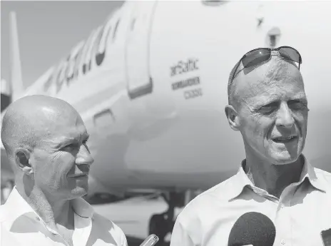  ?? GRAHAM HUGHES/THE CANADIAN PRESS ?? CEOS Alain Bellemare of Bombardier, left, and Tom Enders of Airbus are facing stronger competitio­n after the tie-up between Boeing and Embraer. Analysts believe the deal will be a slight drawback for Bombardier as its main rival Embraer gets a boost.