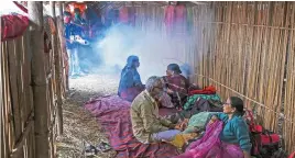  ?? (AFP) ?? Workers fumigate a temporary tent of pilgrims as a preventive measure against COVID-19 during the religious festival of Makar Sankranti on Sagar Island in West Bengal on Wednesday