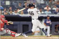  ?? Jim McIsaac / Getty Images ?? The Yankees’ Kyle Higashioka follows through on his fourth inning two-run home run against the Twins.