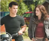  ??  ?? Taylor Lautner and Kristen Stewart as Jacob and Bella