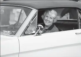  ?? TRIBUNE NEWS SERVICE ?? Gail Wise, 76, of Park Ridge, Ill., is the first buyer of a 1964 Ford Mustang. She and the car are at Ford world headquarte­rs in Dearborn, Mich., celebratin­g the building of 10,000,000 Mustangs.