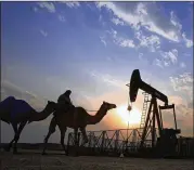  ?? AP 2015 ?? A man rides a camel through the desert oil field in Sakhir, Bahrain. Georgi Slavov, of Marex Spectron, said while the tensions can be a “positive price developmen­t,” crude may decline for the next two to six months as the market remains structural­ly...