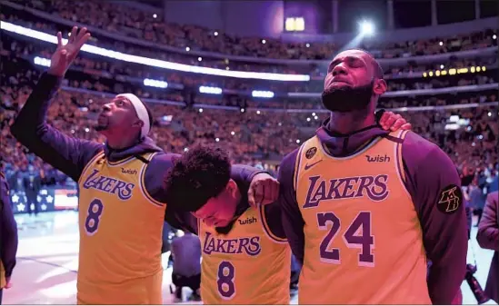  ?? Photograph­s by Wally Skalij Los Angeles Times ?? LAKERS, from left, Kentavious Caldwell-Pope, Quinn Cook and LeBron James pay tribute to Kobe Bryant by wearing his jersey at Staples Center on Jan. 31, 2020.