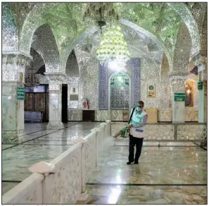  ?? (AP/Ebrahim Noroozi) ?? A worker sprays disinfecta­nt Saturday in the Shiite shrine Saint Imam Abdulazim in the Iranian city of Shahr-e-Ray. A “sacred jihad” against the coronaviru­s has been declared in Iran, where 5,823 cases, including 145 deaths, have been reported. More photos at arkansason­line.com/38covid/.