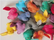  ?? The Associat ed Press ?? Canadian textile artist Cristina Larsen crafts winsome stuffed felted bunnies and chicks in a rainbow of hues.