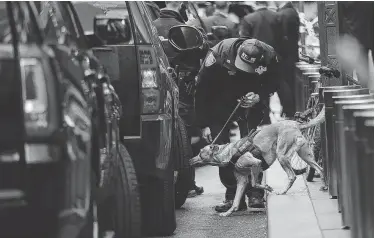  ?? Spencer Platt / Getty Images ?? Police deploy a bomb-sniffing dog outside the Time Warner Center after a pipe bomb was delivered to CNN in New York. Jeff Zucker, the CNN worldwide president, accused President Donald Trump of demonizing journalist­s.