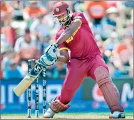  ?? - AFP ?? West Indies batsman Andre Russell hits out against Pakistan at Christchur­ch on February 21, 2015.