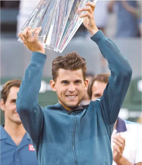  ?? — USA Today Sports ?? Dominic Thiem holds the championsh­ip trophy after defeating Roger Federer.