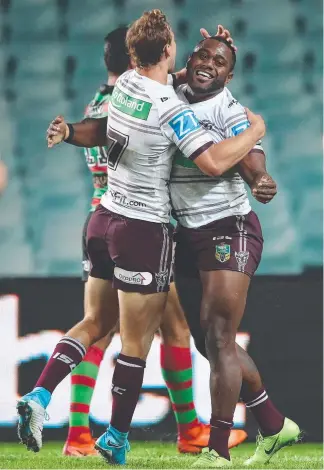  ??  ?? Manly winger Akuila Uate is congratula­ted by Daly Cherry-Evans after scoring a try last night.