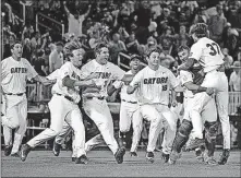  ?? [STEVEN BRANSCOMBE-USA TODAY SPORTS] ?? Florida pitcher Jackson Kowar (37) celebrates with teammates after defeating LSU to win the title on Tuesday in Omaha, Neb.