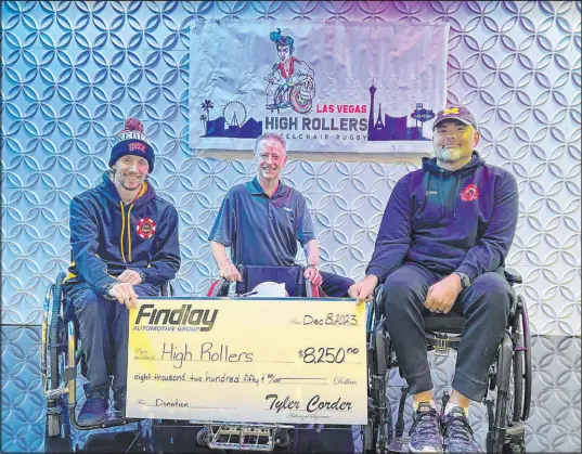  ?? Findlay Automotive ?? Las Vegas High Rollers wheelchair rugby players Bradley Boe, left, and Mike Romanowski, right, with Tyler Corder, Findlay Automotive CFO, who recently presented the team with a check for $8,250 — enough to purchase a sport-ready wheelchair for a player.