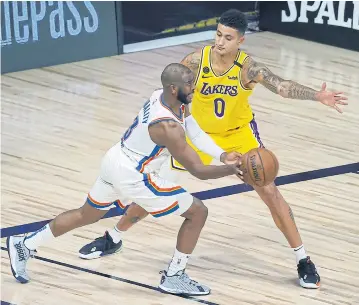  ?? USA TODAY SPORTS ?? The Lakers’ Kyle Kuzma defends against the Thunder’s Chris Paul during the third quarter.