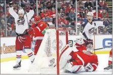  ?? [PAUL SANCYA/THE ASSOCIATED PRESS] ?? Blue Jackets center Brandon Dubinsky, left, celebrates with linemate Boone Jenner after scoring on Red Wings goaltender Petr Mrazek on Feb. 7.