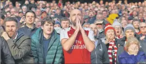  ?? GETTY IMAGES ?? A tense Arsenal supporter during a match against Tottenham Hotspur.