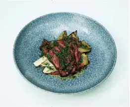  ??  ?? Above Hanger steak with charred endive and horseradis­h gremolata. Opposite Charred squid with black lentils
