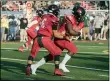  ?? JENNIFER FORBUS — FOR THE MORNING JOURNAL ?? Elyria’s Ryan Klotz (6) hands off to Lance Glover on Aug. 20.