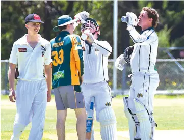  ??  ?? Opening duo Grant Duncan (left) and Damon Healy stop for a drink during one of the great partnershi­ps the WDCA has ever seen, the pair putting on 245 for the first wicket on Saturday afternoon.