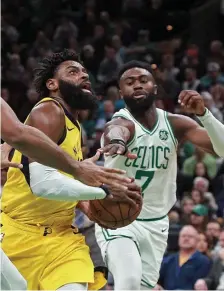  ?? MATT STONE / BOSTON HERALD ?? ALL-AROUND EFFORT: Jaylen Brown tries to strip the ball from the Pacers’ Tyreke Evans last night.