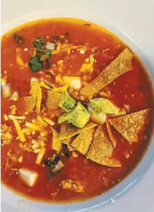  ?? PHOTOS BY DIANE GALAMBOS ?? Left: The Sopa Azteca from Maria’s Tortas Jalisco had a tomato base with chicken, and delicious garnishes.