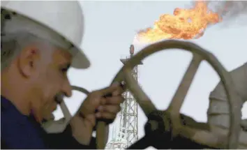  ?? — Reuters ?? An Iraqi worker opens a pipe at Sheaiba oil refinery in Basra, 550 km south of Baghdad.