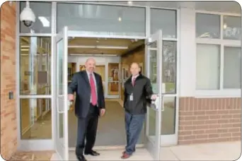  ??  ?? Holland Elementary School Principal Andy Sanko, left, and Council Rock School District’s Supervisor of Operationa­l Services Doug Taylor, show off the school’s new entrance foyer.