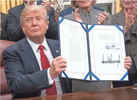  ?? EUROPEAN PRESS AGENCY ?? President Donald Trump signs a bipartisan bill Wednesday to stop the flow of opioids into the United States.