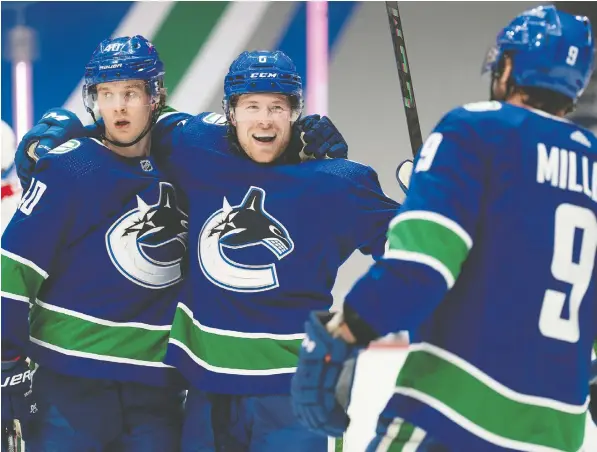  ?? THE CANADIAN PRESS FILES ?? Linemate and good friend Brock Boeser, centre, citing his own past experience with wrist injuries, knows what sidelined Canucks star Elias Pettersson, left, is going through — though the nature of the particular ailment has not been confirmed yet.