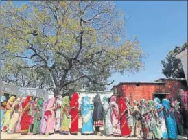  ?? AP ?? Women stand in a queue to cast their votes at a polling station on the outskirts of Allahabad during the fourth phase of election in Uttar Pradesh on Thursday.