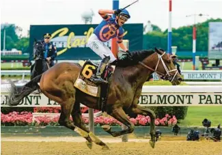  ?? FRANK FRANKLIN II/AP ?? Mo Donegal, with jockey Irad Ortiz Jr., crosses the finish line to win the 154th running of the Belmont Stakes on Saturday at Belmont Park in Elmont, N.Y.