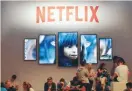  ?? — Reuters ?? Gamers and visitors take a rest at the booth of Netflix during Europe’s leading digital games fair Gamescom in Cologne, Germany, August 21, 2019.