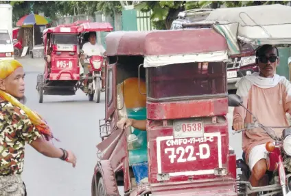  ?? SUNSTAR FOTO/ ALLAN CUIZON ?? FARE HIKE. Tricycle drivers in Mandaue City say nothing is left of their day’s earnings after paying for gas and unit rental. They hope that City Hall would grant their request for a fare increase.