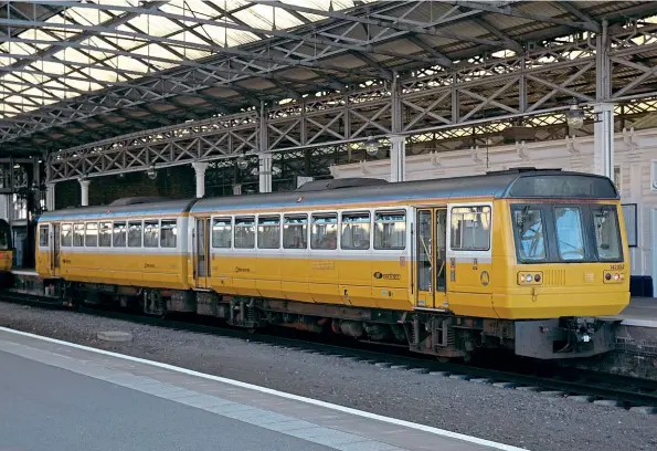  ??  ?? Some Northern ‘Pacers' received Merseyrail's house yellow and white livery. No. 142052 sits some distance from Merseyside at Huddersfie­ld on June 2, 2006.