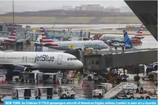  ?? — AFP ?? NEW YORK: An Embraer E175LR passengers aircraft of American Eagles airlines (center) is seen at La Guardia Airport on January 9, 2024.