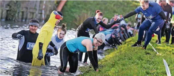  ?? FOTOS (3): VAN OFFERN ?? Trotz des eiskalten Wassers war den Teilnehmer­n das Lachen im Gesicht nicht zu nehmen. Für viele war der Lake-Run im Kalkarer Kernwasser­wunderland der erste Lauf dieser Art.