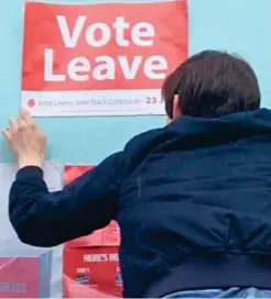  ??  ?? Hostile: Student Remy Osman puts up Leave banner