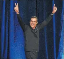  ?? PETE BANNAN — DIGITAL FIRST MEDIA ?? Villanova coach Jay Wright gives the “V” salute as the Wildcats returned to campus at Nevin Field House.