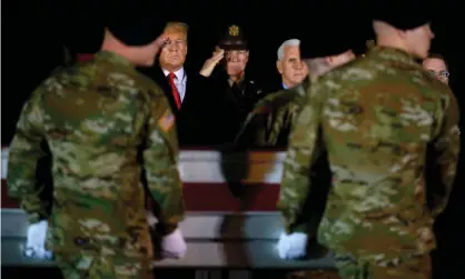  ??  ?? Donald Trump and vice-president Mike Pence observe the transfer of two US soldiers, killed in Afghanista­n, at Dover Air Force Base in Dover, Delaware, on 11 February. Photograph: Jim Watson/AFP via Getty Images