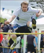  ??  ?? Stewart Clark clears the high jump bar.