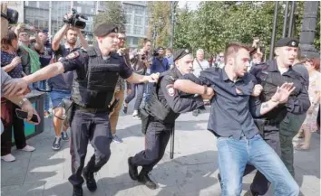  ?? — Reuters ?? Police officers detain a protester during a rally against planned increases to the nationwide pension age in Moscow.