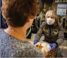  ?? ?? Below: Gov. Michelle Lujan Grisham serves dinner to wildfire evacuees on Wednesday (May 4) at the Peñasco evacuation center.